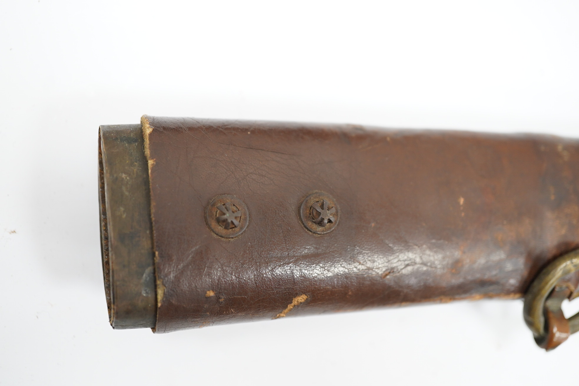 A WWII Japanese army officer’s Shingunto sword katana, blade 66.4cm, signed with Showa to stamp (tip of blade damaged), with unusual brass mounts, in its leather covered combat scabbard. Condition - poor to fair